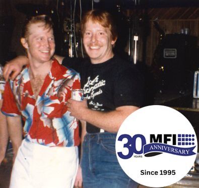 Mike and Tom Mathisen with the MFI 30th Anniversary logo.